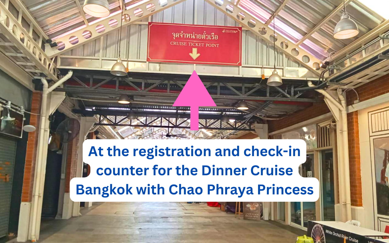 Signage showing the way to check in for the Chao Phraya River Cruise